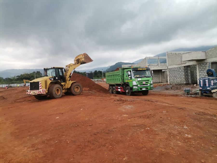 Loader and dump trucks performing earthworks