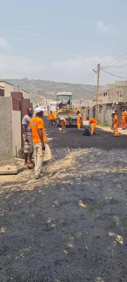 Workers compacting a fresh road surface