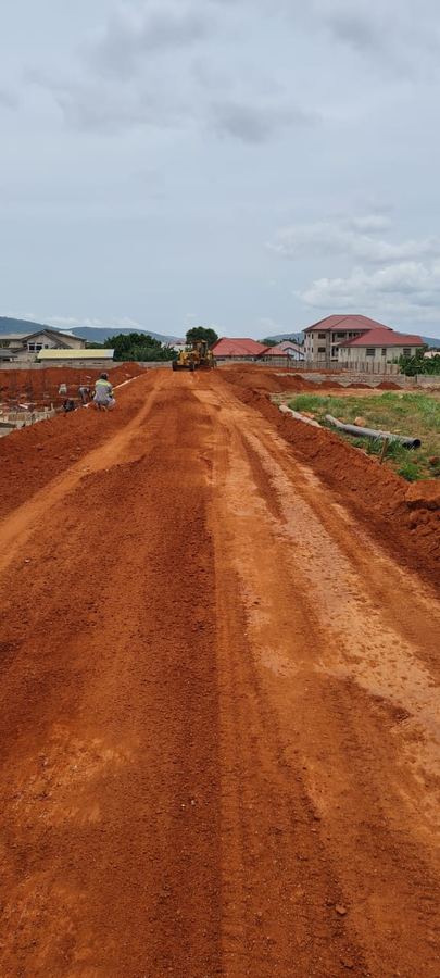 Road cutting through green hills